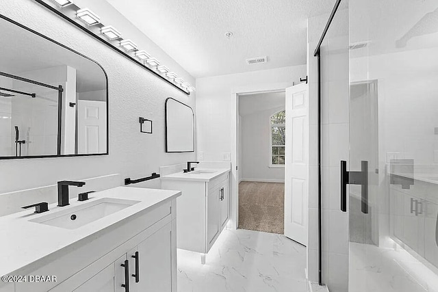 bathroom featuring vanity, a textured ceiling, and walk in shower