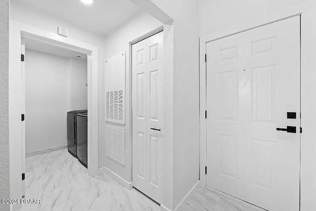 corridor featuring washing machine and dryer