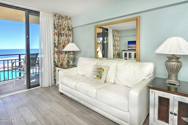 2301 S Atlantic Ave Unit 315, Daytona Beach, FL 32118 - living room with a water view and light hardwood / wood-style flooring