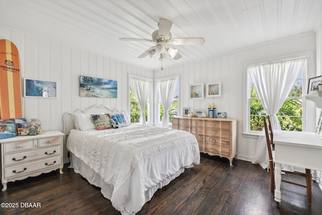 bedroom with dark wood-style floors, ceiling fan, and multiple windows