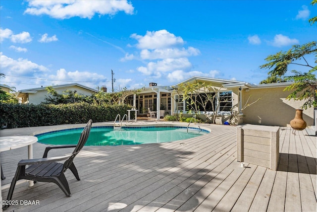 view of swimming pool with a fenced in pool and a deck