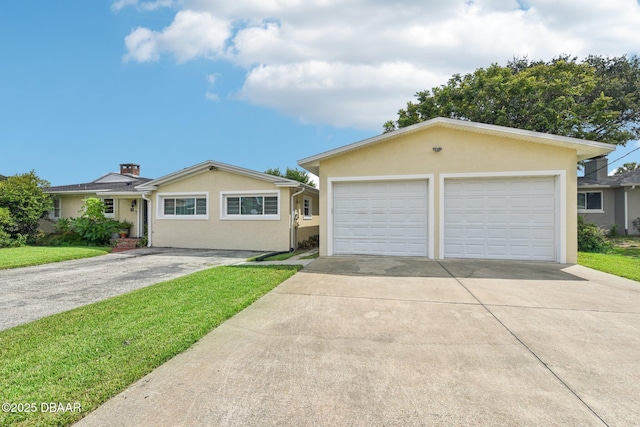 single story home featuring a front lawn, a detached garage, and stucco siding