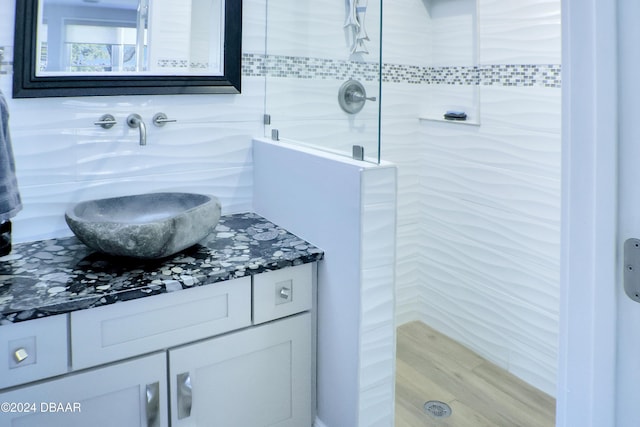 bathroom featuring vanity and a tile shower