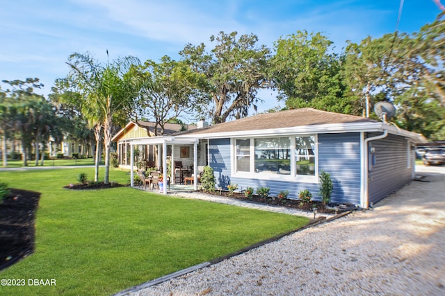 rear view of house featuring a lawn