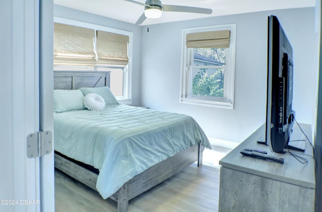 bedroom with ceiling fan and light hardwood / wood-style floors