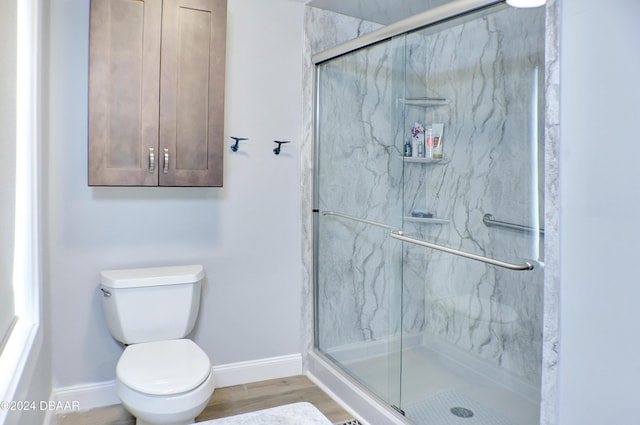 bathroom with walk in shower, wood-type flooring, and toilet