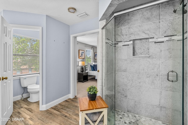 1197 Southfork Ct, Port Orange, FL 32129 - ensuite bathroom featuring a stall shower, healthy amount of natural light, and wood finished floors