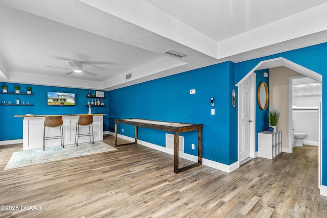 1197 Southfork Ct, Port Orange, FL 32129 - unfurnished office featuring ceiling fan, a dry bar, wood finished floors, and a tray ceiling