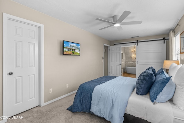 1197 Southfork Ct, Port Orange, FL 32129 - carpeted bedroom with a barn door, ensuite bath, and ceiling fan