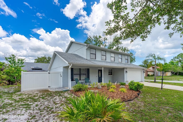 1197 Southfork Ct, Port Orange, FL 32129 - view of front facade featuring driveway, covered porch, an attached garage, brick siding, and roof with shingles