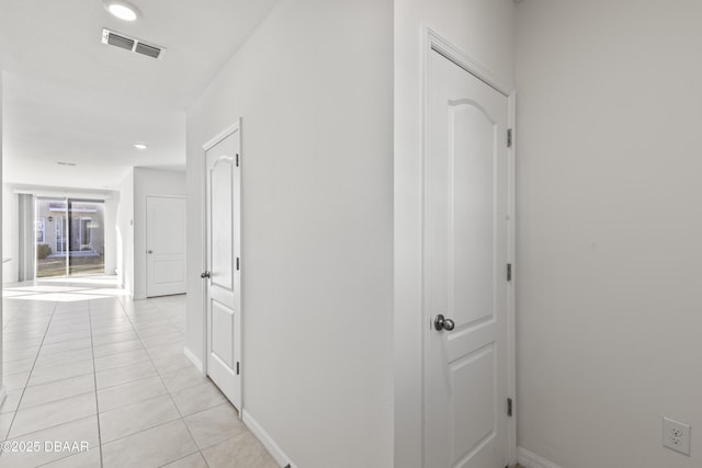 hall featuring light tile patterned floors