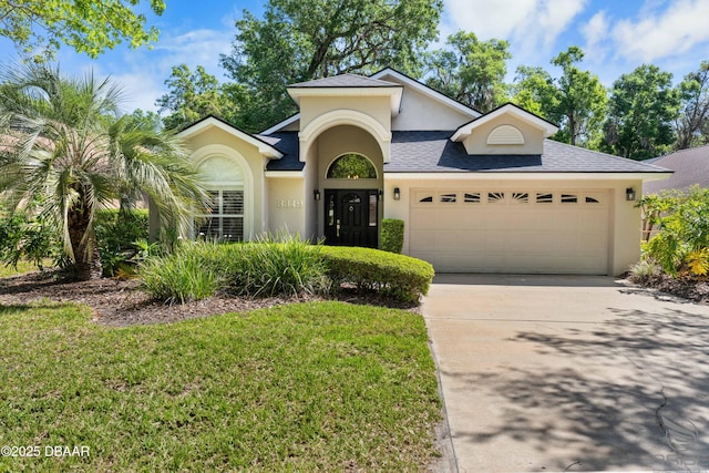 3349 Glenshane Way, Ormond Beach, FL 32174 - view of front of property with stucco siding, an attached garage, concrete driveway, a shingled roof, and a front lawn