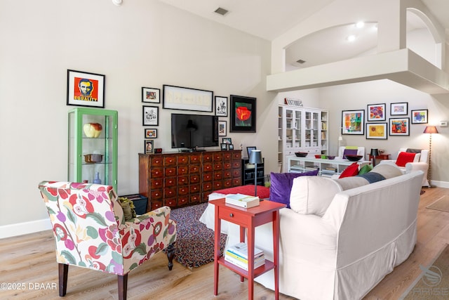 3349 Glenshane Way, Ormond Beach, FL 32174 - living area featuring wood finished floors, baseboards, and high vaulted ceiling