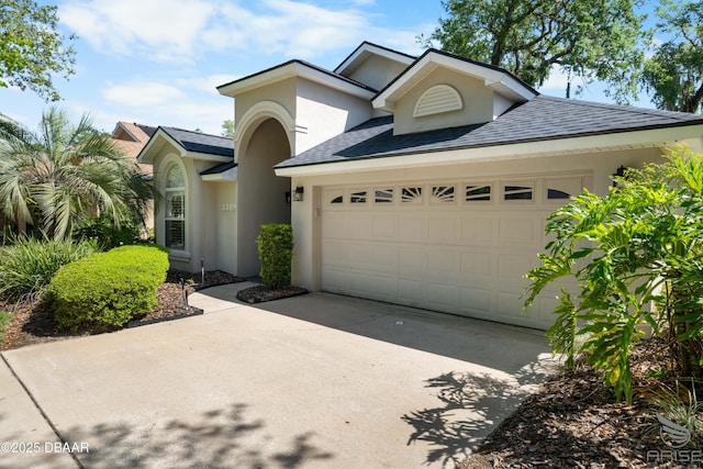 3349 Glenshane Way, Ormond Beach, FL 32174 - view of front of property with a garage, stucco siding, concrete driveway, and a shingled roof