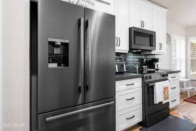 3349 Glenshane Way, Ormond Beach, FL 32174 - kitchen with stainless steel refrigerator with ice dispenser, dark countertops, electric range, light wood finished floors, and backsplash