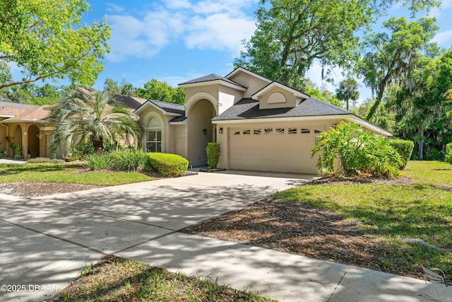3349 Glenshane Way, Ormond Beach, FL 32174 - view of front of property with stucco siding, a garage, driveway, and a shingled roof