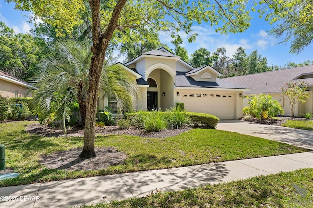 3349 Glenshane Way, Ormond Beach, FL 32174 - view of front of house featuring stucco siding, a garage, driveway, and a front yard