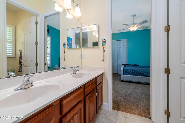 1491 Hohe Ln, Ormond Beach, FL 32174 - bathroom featuring ceiling fan, double vanity, connected bathroom, and tile patterned floors