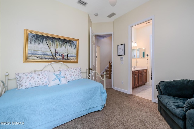 1491 Hohe Ln, Ormond Beach, FL 32174 - bedroom with light colored carpet, ensuite bath, a sink, and baseboards