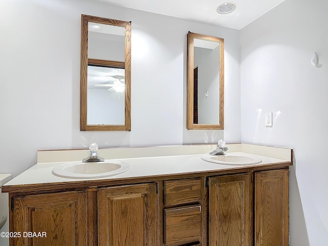 full bathroom with double vanity, ceiling fan, and a sink