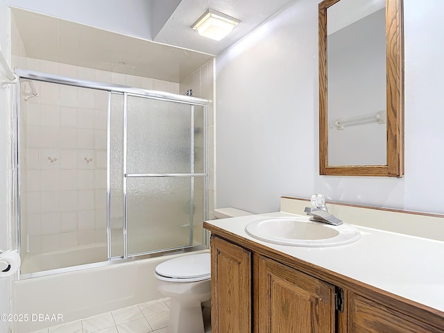 bathroom with shower / bath combination with glass door, vanity, and toilet