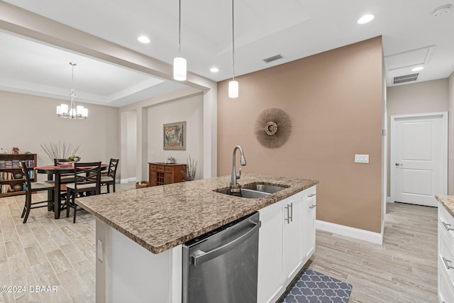 kitchen featuring a center island with sink, dishwasher, sink, white cabinetry, and decorative light fixtures