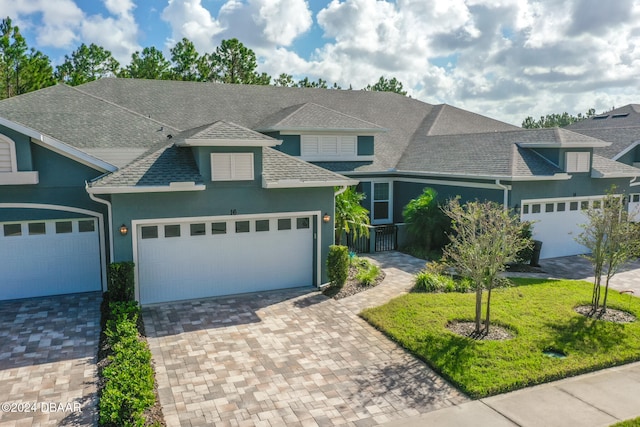 view of front of home with a garage and a front yard