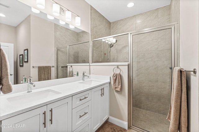 bathroom with vanity and a shower with door