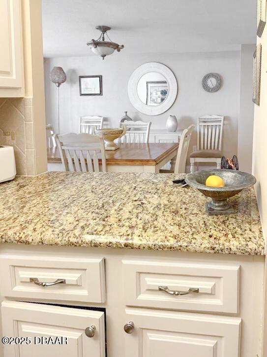 3043 S Atlantic Ave Unit 204, Daytona Beach Shores, FL 32118 - kitchen with light stone counters and backsplash