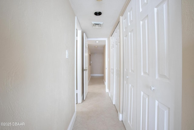 3043 S Atlantic Ave Unit 204, Daytona Beach Shores, FL 32118 - hallway featuring baseboards and light tile patterned flooring