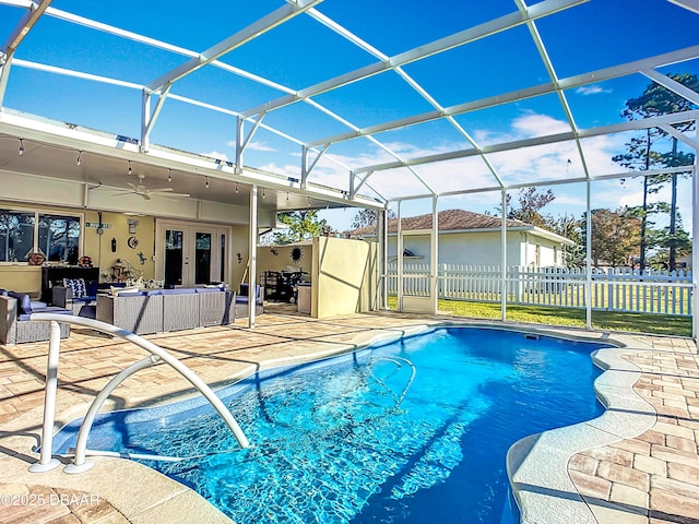 view of pool with an outdoor hangout area, ceiling fan, french doors, a patio, and glass enclosure