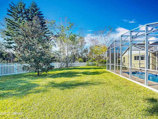 view of yard with a lanai and a fenced in pool