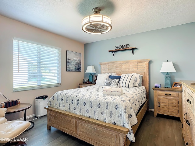 bedroom with dark hardwood / wood-style flooring and a textured ceiling