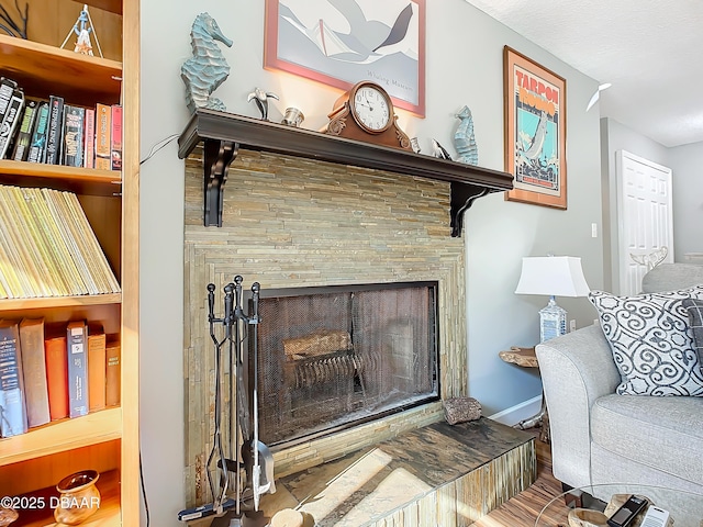 interior details with a tile fireplace and built in features