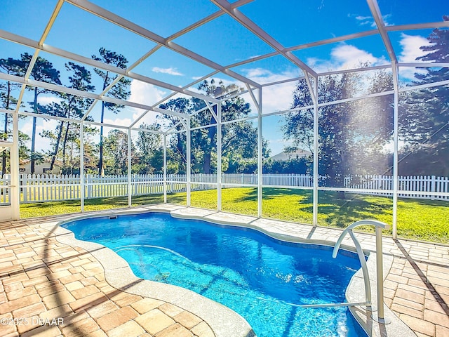 view of swimming pool with a patio, glass enclosure, and a lawn