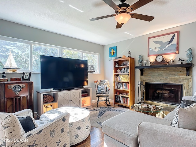 living room featuring wood-type flooring, a textured ceiling, and ceiling fan