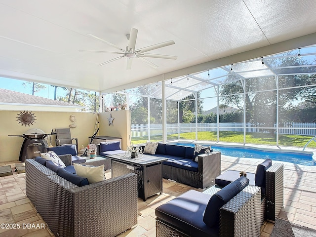 sunroom with a healthy amount of sunlight, a swimming pool, and ceiling fan