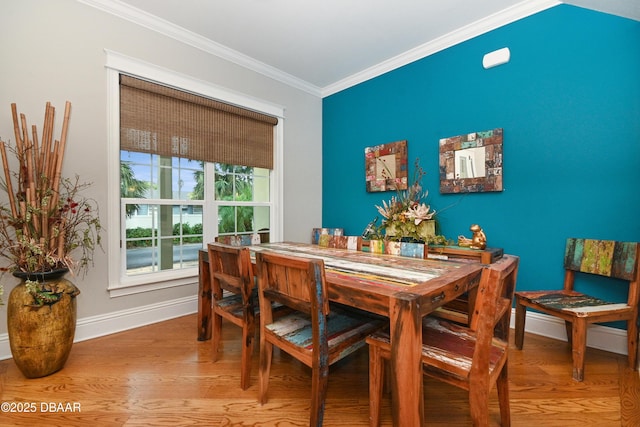 dining area with hardwood / wood-style floors and ornamental molding