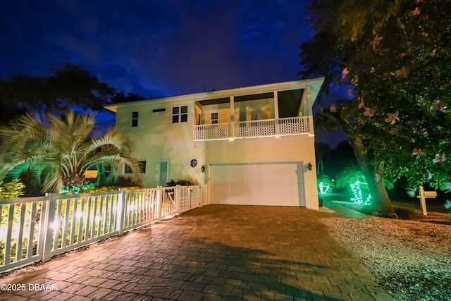 view of front of house with a balcony and a garage