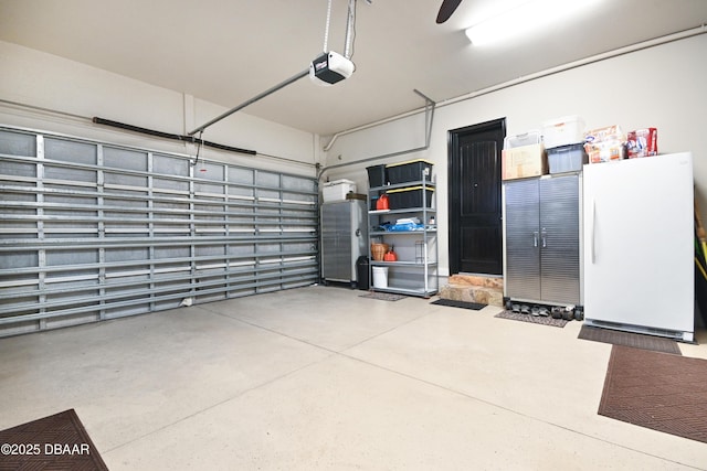 garage with white fridge and a garage door opener