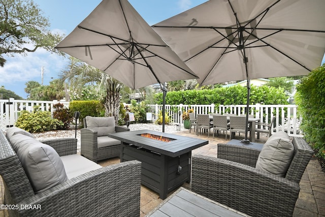 wooden terrace with an outdoor living space with a fire pit