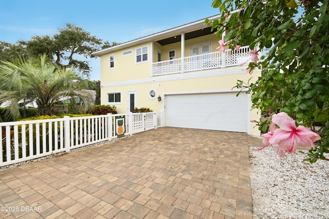 view of front facade featuring a balcony and a garage