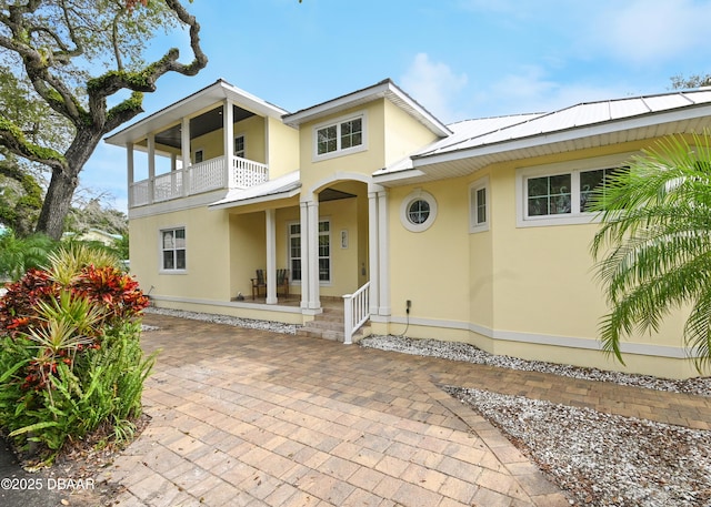 view of front of house featuring a balcony