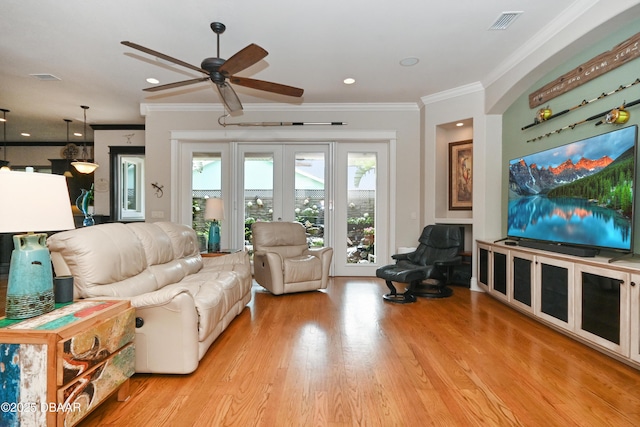 living room with ceiling fan, french doors, crown molding, and light hardwood / wood-style flooring