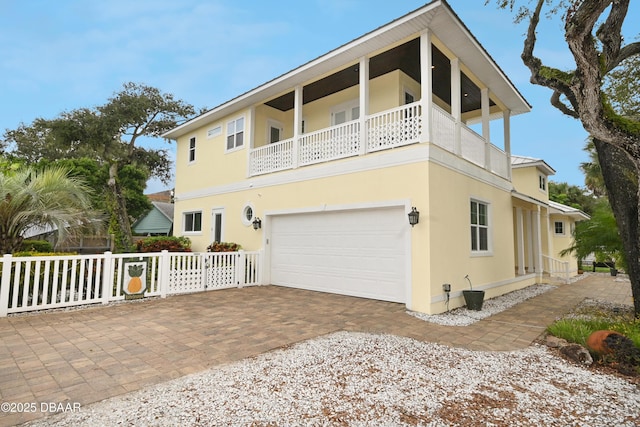 view of front facade featuring a balcony and a garage