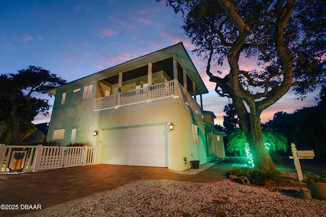 view of front of home featuring a balcony and a garage