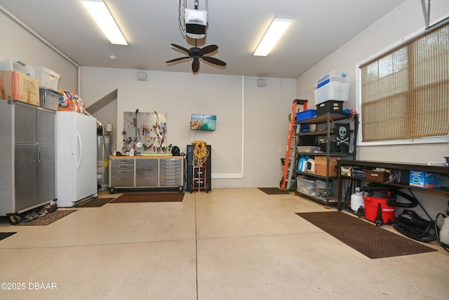 garage featuring white fridge, a garage door opener, a workshop area, water heater, and ceiling fan