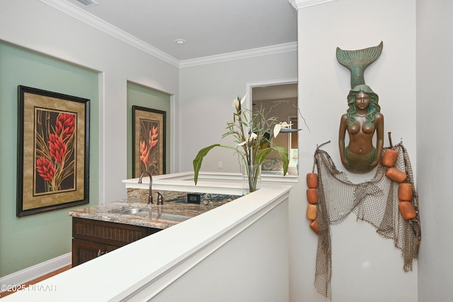 interior space with vanity and ornamental molding