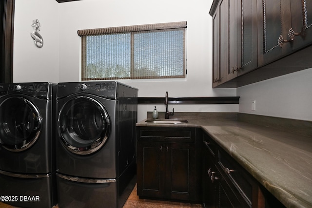 laundry room featuring cabinets, separate washer and dryer, and sink