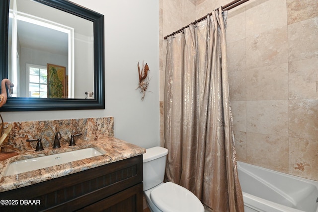 full bathroom featuring shower / bath combo, vanity, and toilet